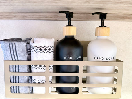 Neat RV rental organization: black dish soap, white hand soap, and towels in a modern caddy, ready for a clean adventure.