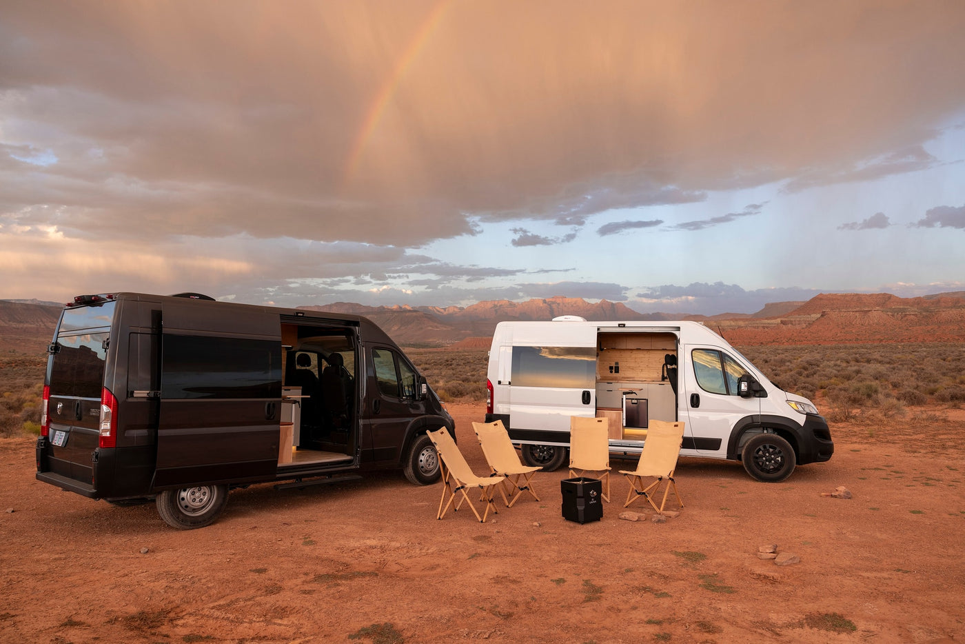 Two modern camper vans, black and white, set up for camping in a scenic desert landscape with a rainbow. Perfect RV rental adventure. — photo 14