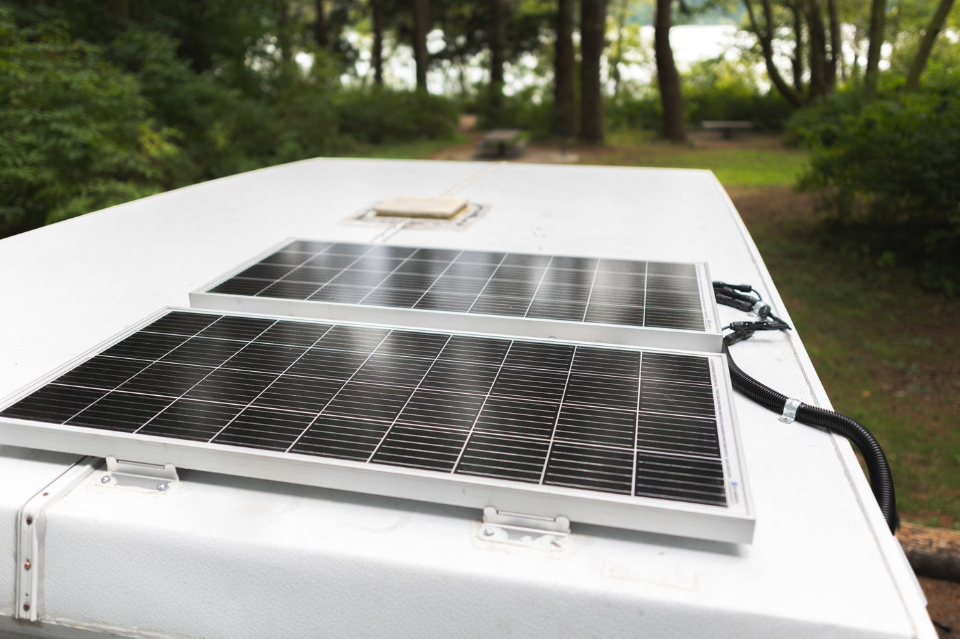 Two solar panels on a white RV roof, wired for power. Perfect for your next RV rental adventure. — photo 16