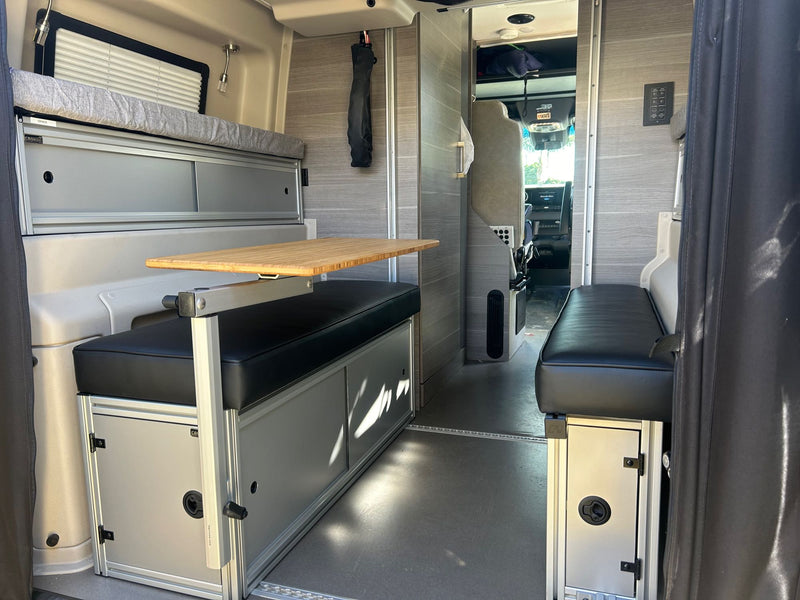  a golden and a cream one.|Compact RV rental kitchen setup featuring a built-in microwave — photo 13