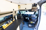 Detailed RV rental interior: custom camper van conversion with cockpit, compact kitchen, and smart storage solutions for travel.