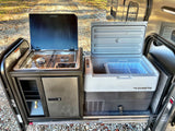 An RV rental's dream: Dometic outdoor kitchen with a two-burner stove and a large portable fridge, perfect for camping!