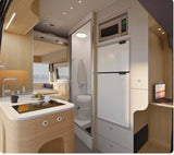 Modern RV rental interior: compact kitchen with stove, sink, microwave, fridge, plus bathroom & living/sleeping area.