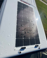 This RV rental features a rooftop solar panel, seen here sparkling with water droplets after a recent wash.