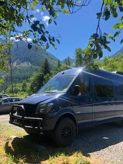 Blue RV rental camper van parked in a scenic mountain valley, perfect for your next outdoor adventure. — photo 19