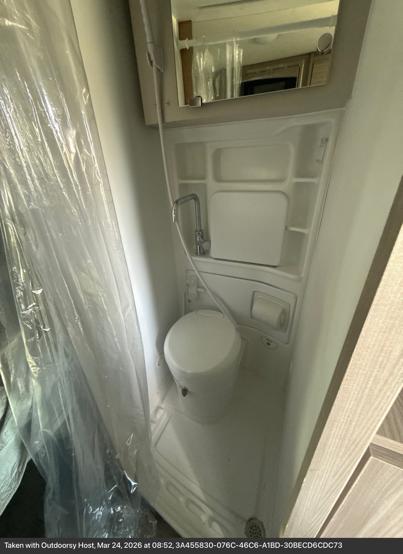  bug screen. Parked lakeside with awning & bike rack ready for outdoor adventure.|Compact RV rental kitchen with sink — photo 3