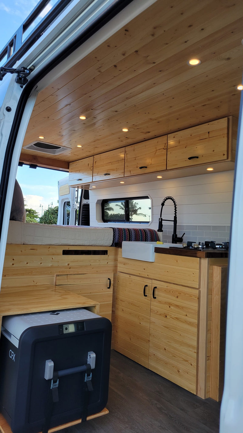  and cooler on grey wood floor.|Modern RV rental interior: wood ceiling — photo 7