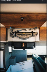 RV interior: Compact pull-out shower, integrated storage, and a reflection of the photographer. Great for an rv rental & mobile living.
