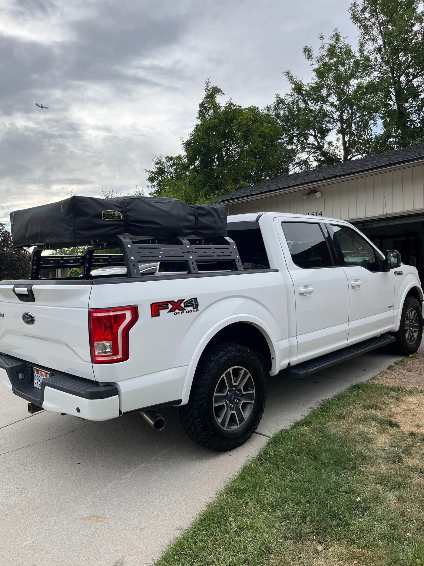 White Ford F-150 truck with rooftop tent for camping, a versatile alternative to an RV rental. — photo 19