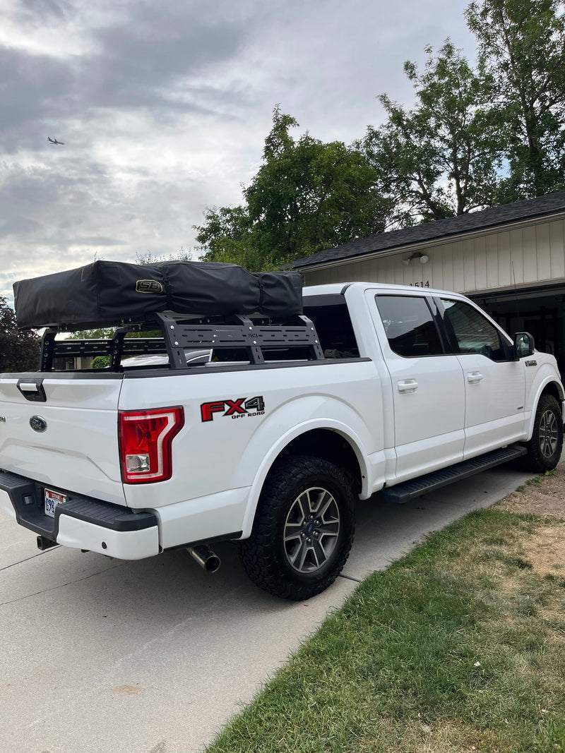 White Ford F-150 truck with rooftop tent for camping, a versatile alternative to an RV rental. — photo 19