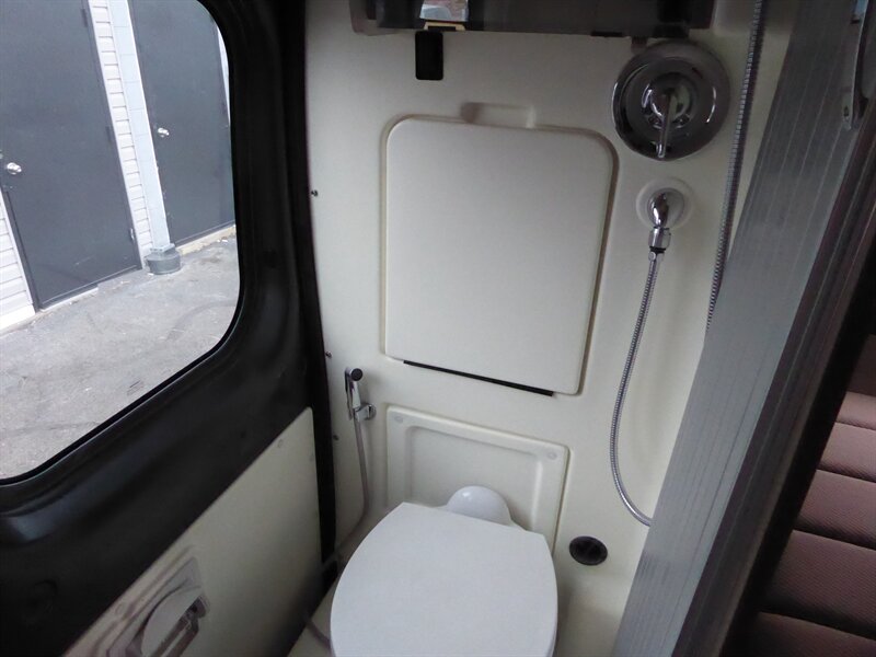  and storage unit with power outlets. Perfect for travel!|Rear view of an RV rental with open doors — photo 17