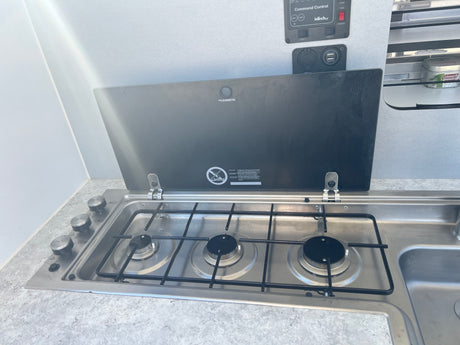 RV rental kitchen: Dometic stove/sink unit, control panel, and USB ports for comfortable cooking on the go.