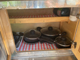  and lower wood cabinets.|Open rear hatch of a yellow teardrop rv rental