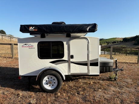 Runaway Kingtyme rv rental travel trailer with a Naturnist rooftop awning, ideal for camping adventures.