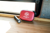 Stay safe in your rv rental with essential items: a red first aid kit and flashlight on a wooden counter.