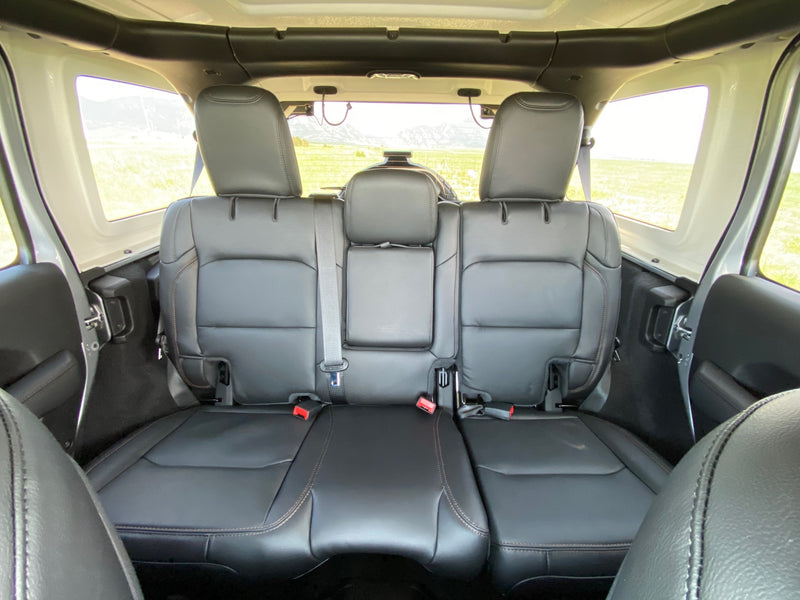 Interior of an SUV-style RV rental: black leather back seats, headrests, and scenic views of fields and mountains. — photo 6