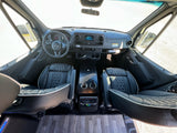 RV rental interior: Premium cockpit with modern dashboard, black quilted seats, and spacious design.