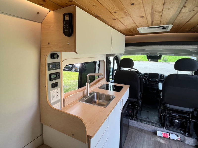  and living area.|Modern rv rental van kitchen: wood ceiling — photo 7