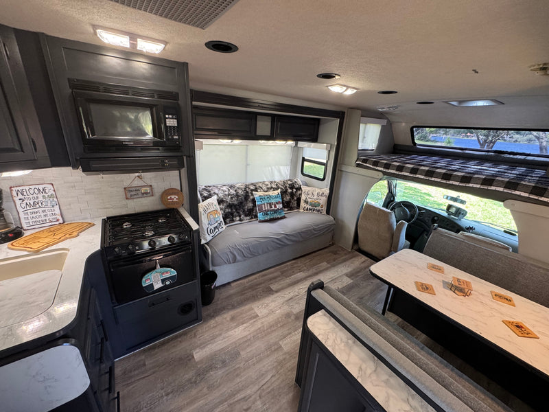 Cozy rv rental interior with kitchen, living, and bunk bed areas, ready for camping adventures by the water. — photo 5