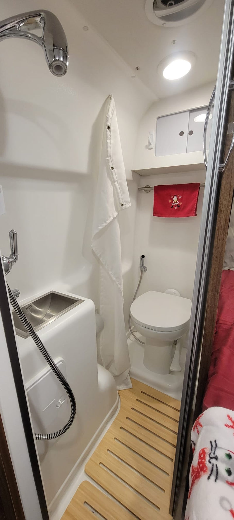  and a compact bathroom with toilet.|Detailed RV rental interior: an efficient kitchen — photo 5