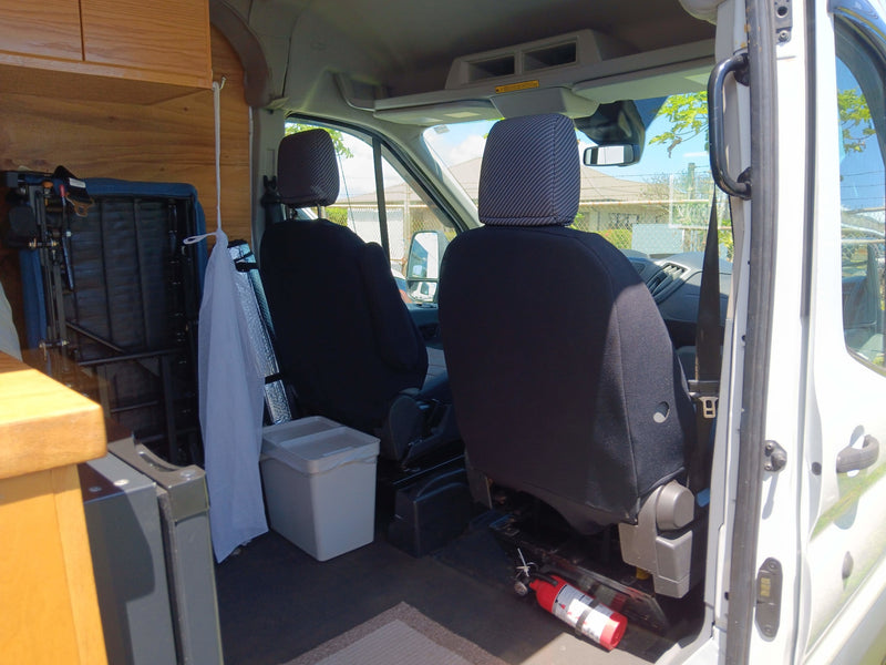 Step inside your next RV rental: comfy seats, ample cab space, and essential safety gear like a fire extinguisher. — photo 13