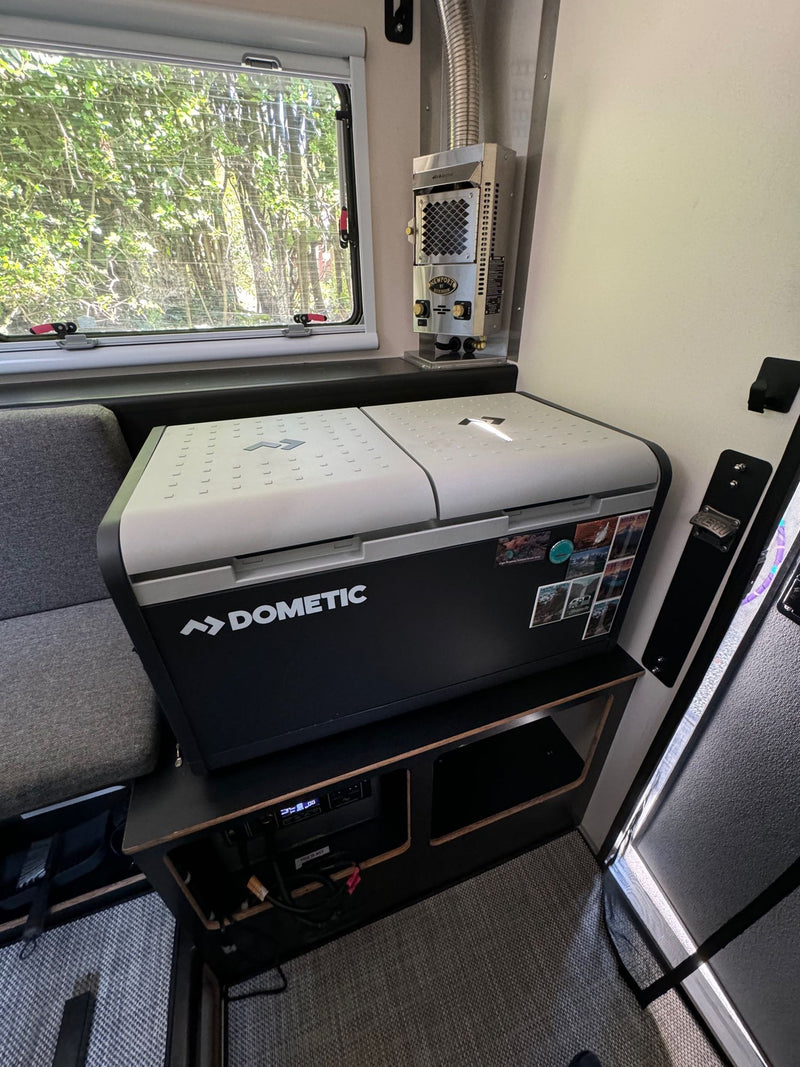 Compact RV rental interior featuring a Dometic cooler, heater, and scenic window view. Perfect for travels. — photo 12
