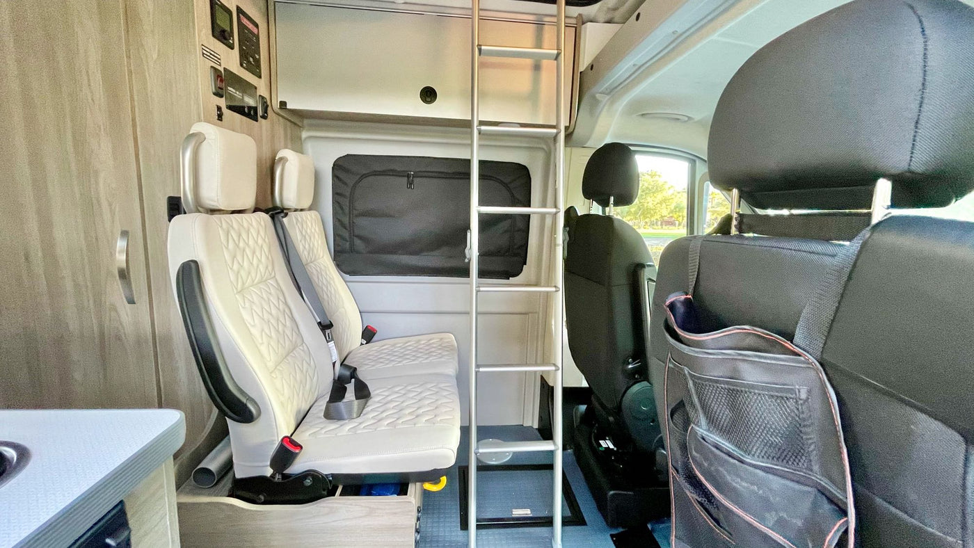  mountains in the distance. An ideal scene for adventure travel.|Cooking fried eggs and another dish on the stovetop inside an RV rental. A compact kitchen setup for road trips.|Inside a modern RV rental — photo 4