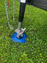 RV rental trailer jack on a blue base in the grass with safety chains, ensuring stable parking.