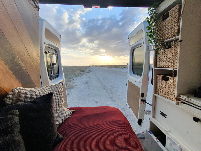  and built-in white and teal storage.|Compact RV rental kitchenette with teal cabinets — photo 12