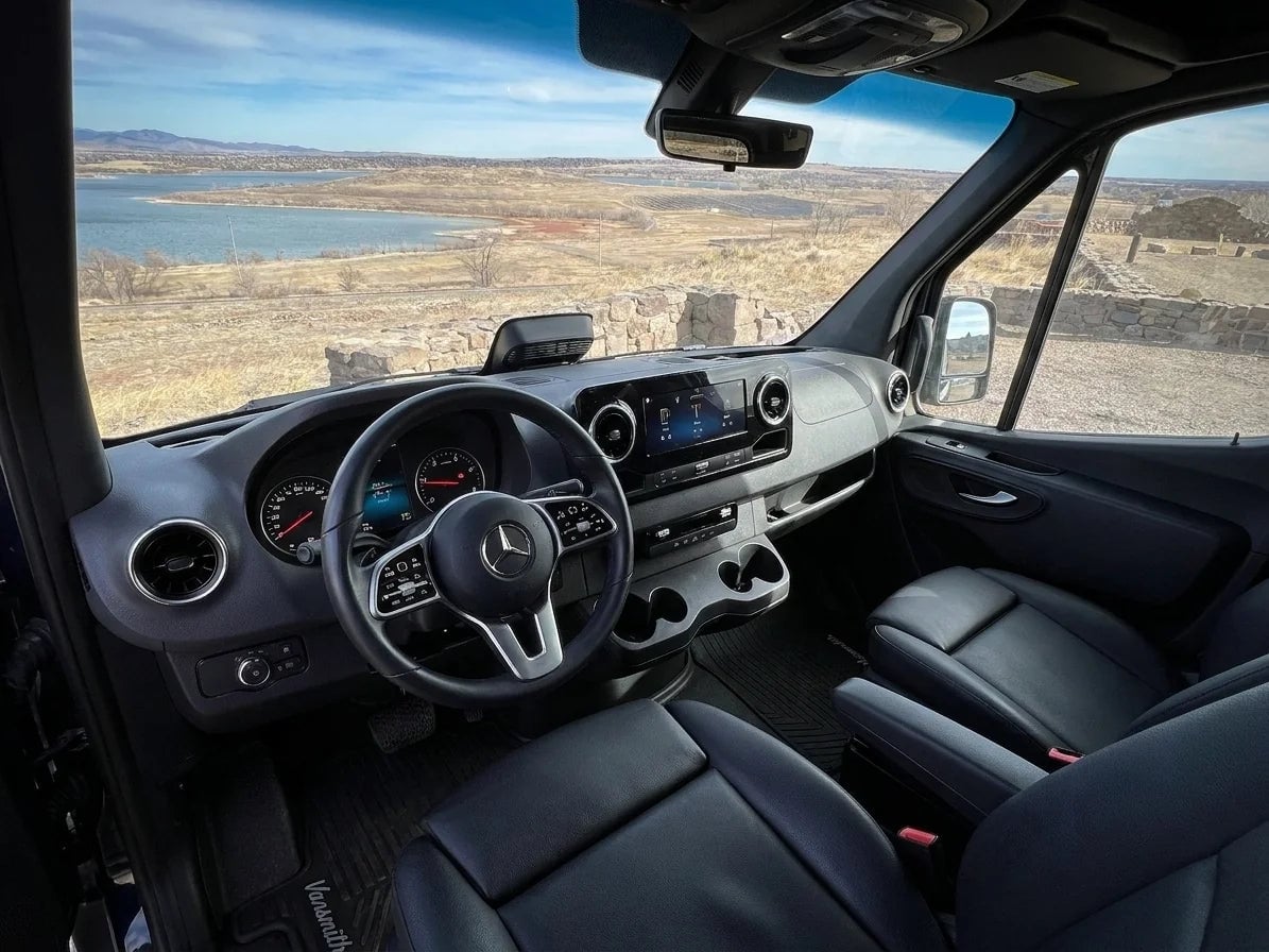  and toilet for your adventure.|Grey RV rental van on a lake shore