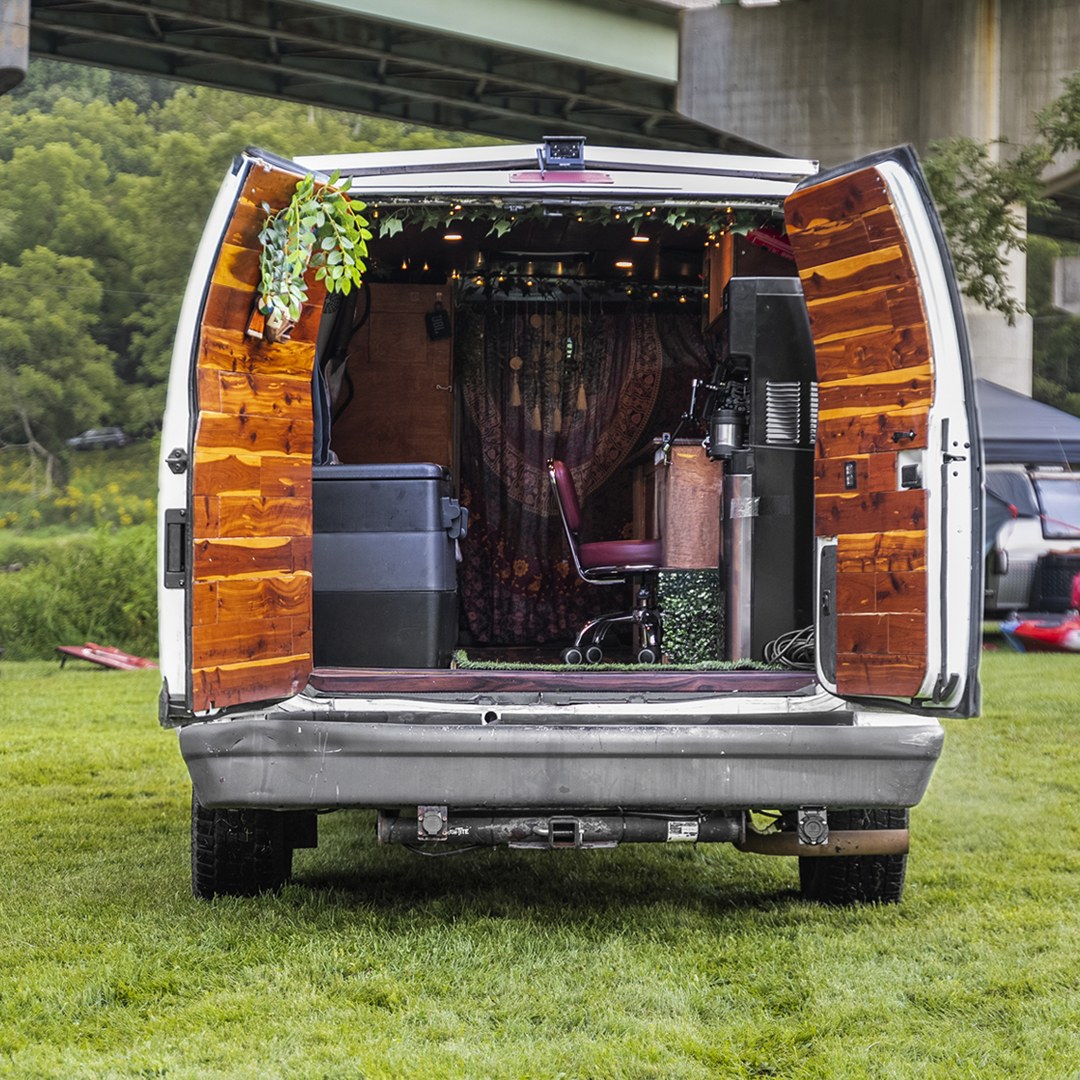  and warm wooden interior with string lights for cozy travel.|This RV rental's cozy interior features floral bench seating