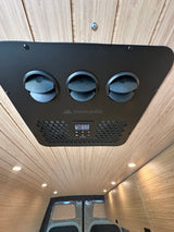 Overhead Nomadic climate control unit in an RV rental van, displaying 65.0. Features wood paneling & recessed lighting.