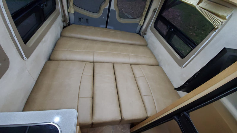  wood cabinets. View outside through open door.|Inside an RV rental — photo 12