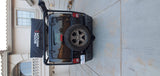 Rear view of a black Jeep Wrangler, equipped with adventure gear. Great for camping and exploring, an RV rental alternative.