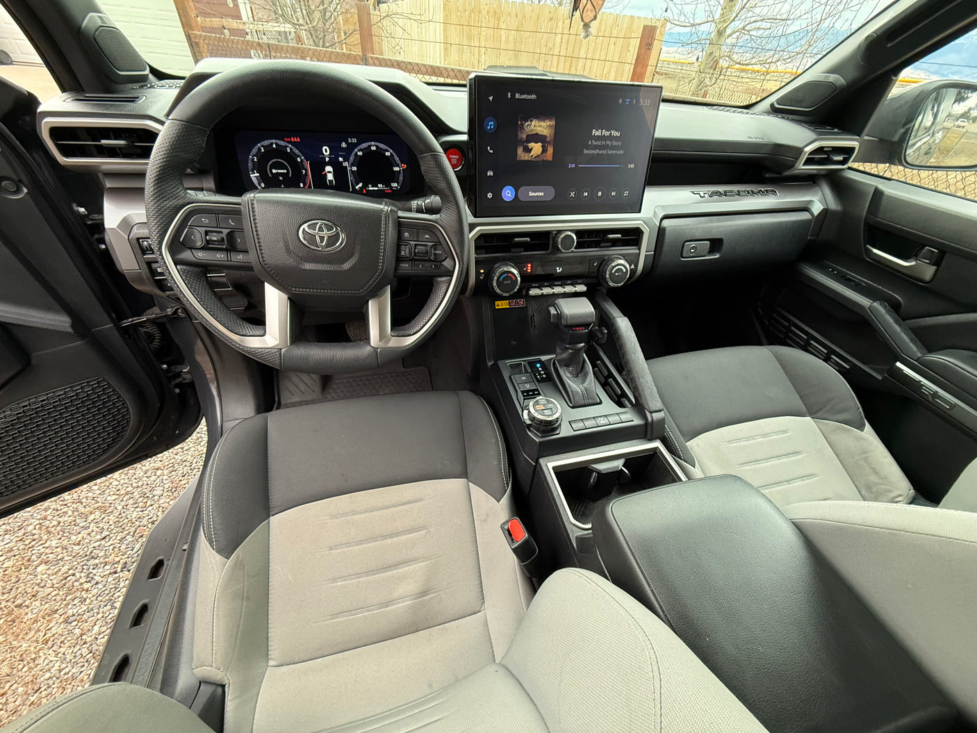 Spacious Toyota Tacoma interior with digital dash, large infotainment, and comfy seats. Perfect for a rugged rv rental trip.