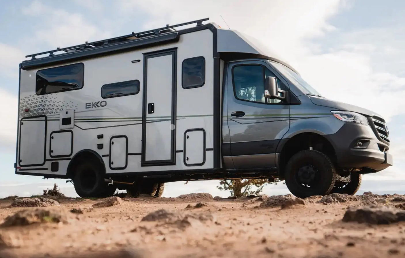 A rugged gray EKKO RV on rocky terrain, ideal for your next rv rental adventure.