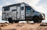 A rugged gray EKKO RV on rocky terrain, ideal for your next rv rental adventure.
