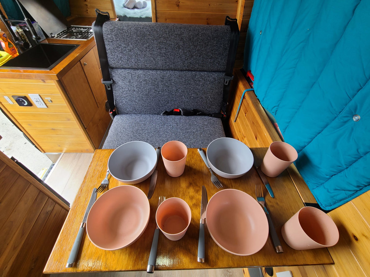  and insulated window covers.|Cozy RV rental interior featuring a compact kitchen with sink and stovetop — photo 13