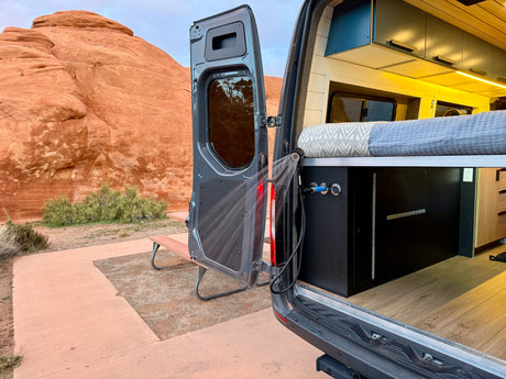 An RV rental camper van with an outdoor shower. Explore the red rock desert and enjoy van life adventures!