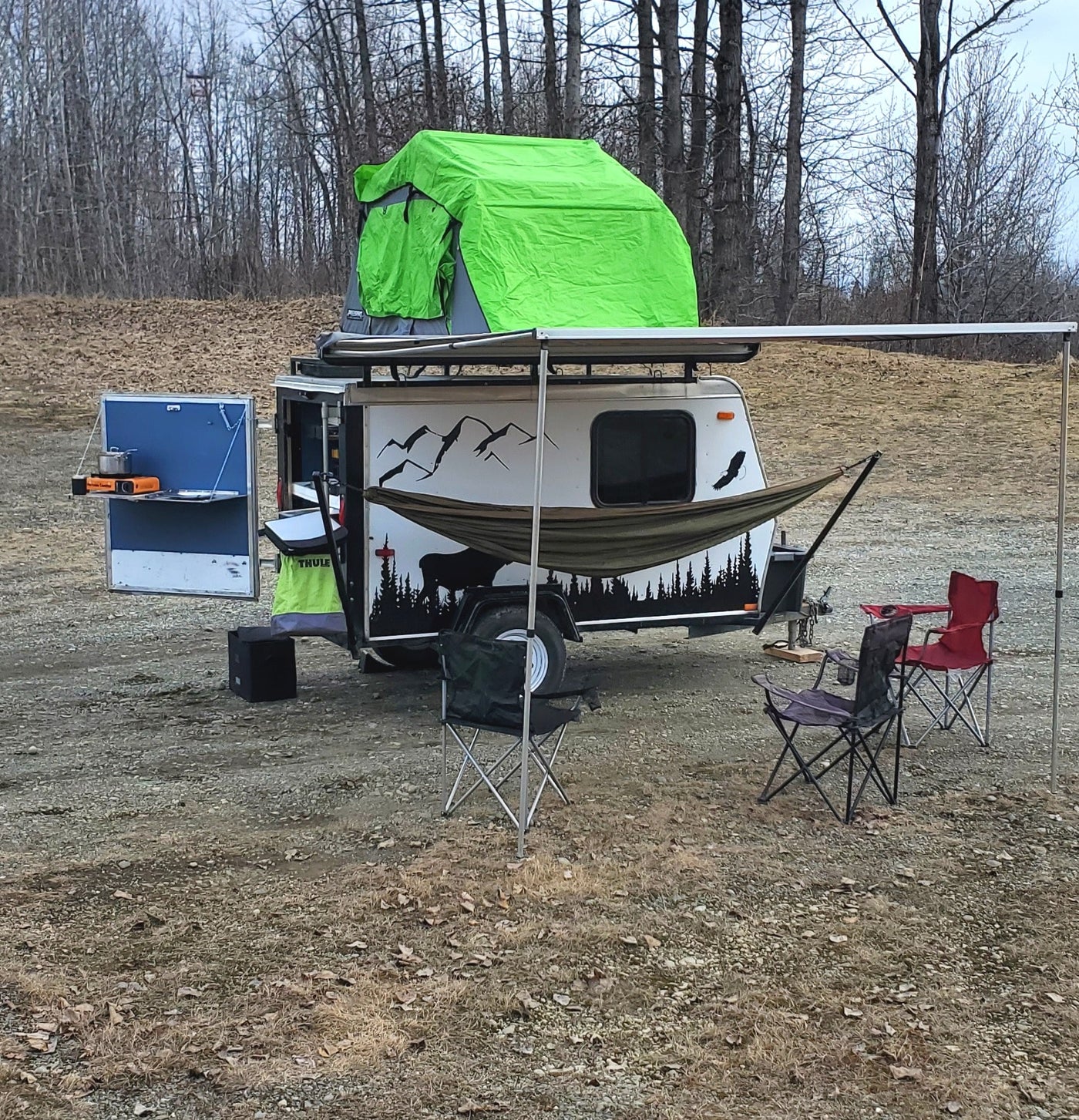 Compact RV rental ready for adventure, with rooftop tent, outdoor kitchen, and chairs for a cozy camp setup. — photo 16