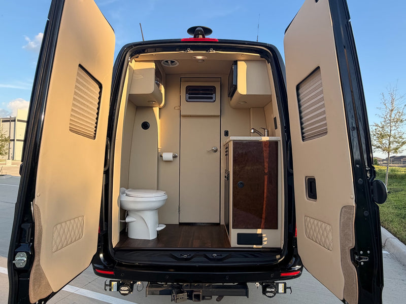  quilted leather captain's chairs and seatbelts.|Luxurious RV rental interior featuring a large ceiling-mounted entertainment screen displaying "No Signal — photo 8