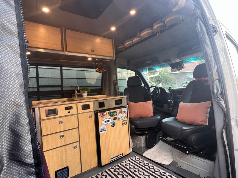 Step inside this cozy RV rental, featuring a compact kitchen, ample storage, and swivel front seats for your next van life adventure. — photo 15