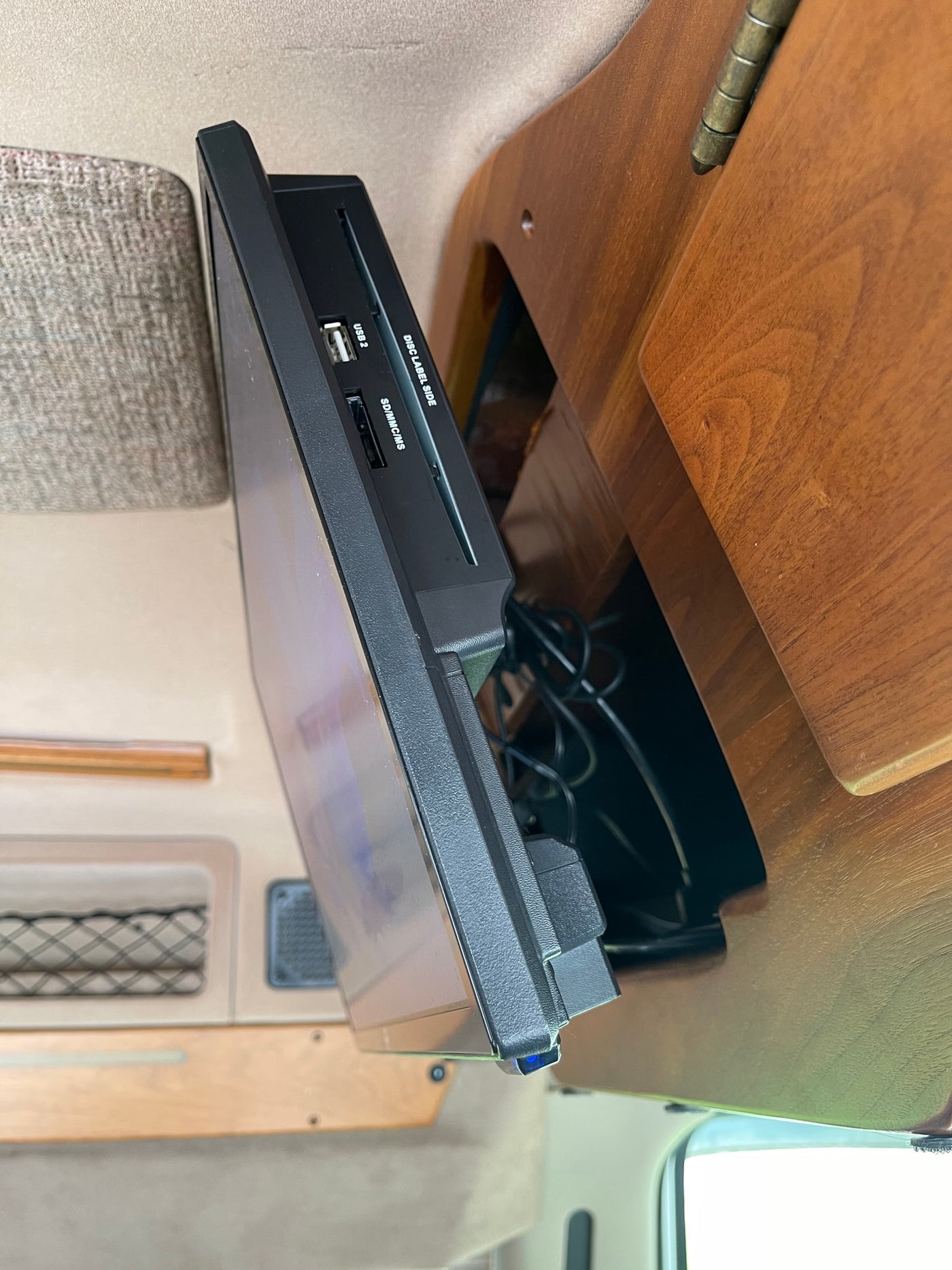  perfect for an RV rental. Parked curbside on a rainy day.|Side view of an RV rental entertainment system: a mounted media player with USB — photo 2