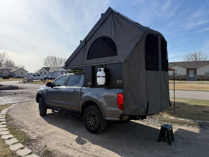 Explore with this RV rental alternative: a Ford Ranger Tremor equipped with an extensive truck camper and rooftop tent setup.