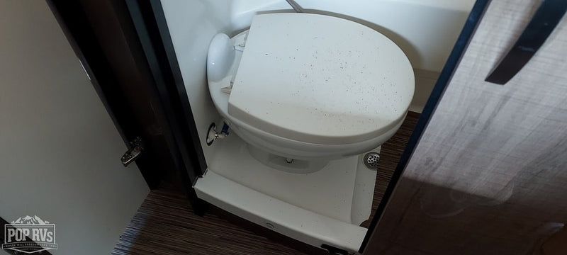 RV bathroom featuring a compact toilet. Essential for any rv rental experience. — photo 10
