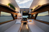 Experience travel with this custom RV rental, boasting a modern wood interior, cozy seating, and expansive scenic window views.