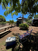 Enjoy your RV rental adventure! Two Jeeps with rooftop tents, a picnic table, chairs, and cooler in a sunny campsite.