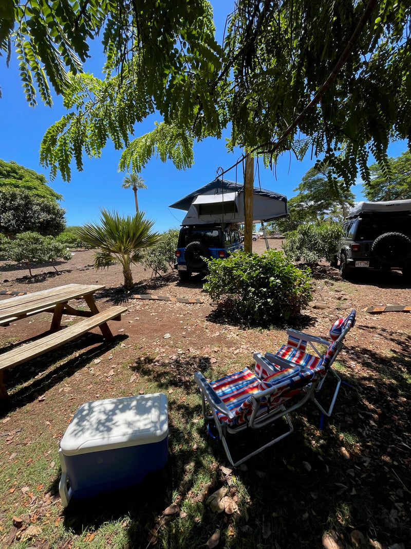 Enjoy your RV rental adventure! Two Jeeps with rooftop tents, a picnic table, chairs, and cooler in a sunny campsite. — photo 16