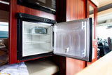 Inside your RV rental: a bright, open refrigerator ready for food, with a microwave visible above.