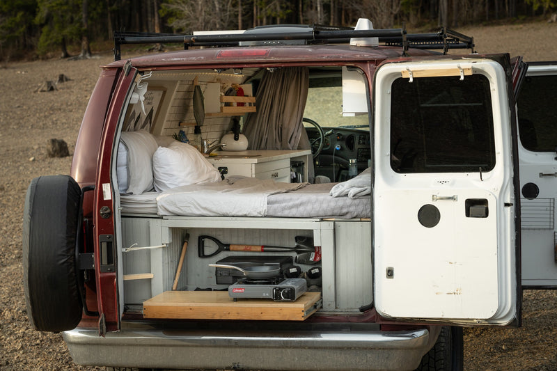  and clever storage.|Experience van life with this RV rental! Functional camper van interior featuring a kitchen — photo 3